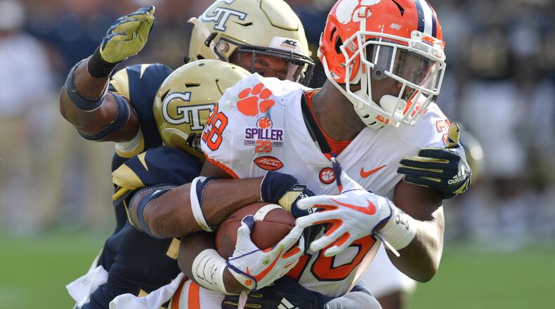 September 22, 2018 Atlanta - Clemson running back Tavien Feaster (28) breaks away for a go-ahead touchdown as Georgia Tech defensive back Tariq Carpenter (29) and Georgia Tech defensive back Malik Rivera (36) try to stop him in the second half at Bobby Dodd Stadium on Saturday, September 22, 2018. HYOSUB SHIN / HSHIN@AJC.COM