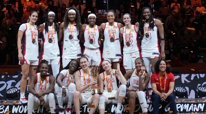 United States plyers pose on the podium after winning the Women's Basketball World Cup final match between the United States and France in Berlin, Sunday, Sept. 13, 2026. (AP Photo/Ebrahim Noroozi)