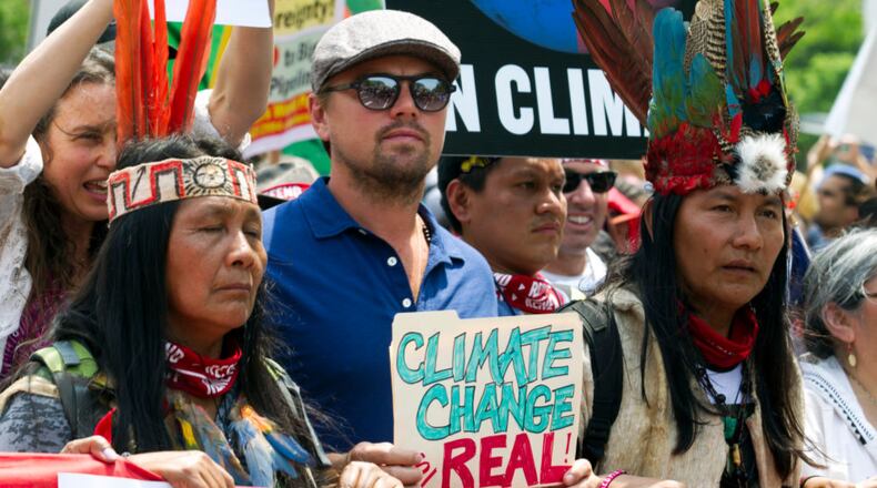 Actor Leonardo DiCaprio (2nd L) marches with a group of indigenous people from North and South America, during the People's Climate March in Washington DC, on April, 29, 2017. (Photo by JOSE LUIS MAGANA/AFP/Getty Images)
