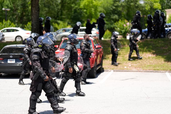 Police break up a crowed during a "No Kings" protest in Dekalb County, near Atlanta, Saturday, June 14, 2025. (AP Photo/Mike Stewart)