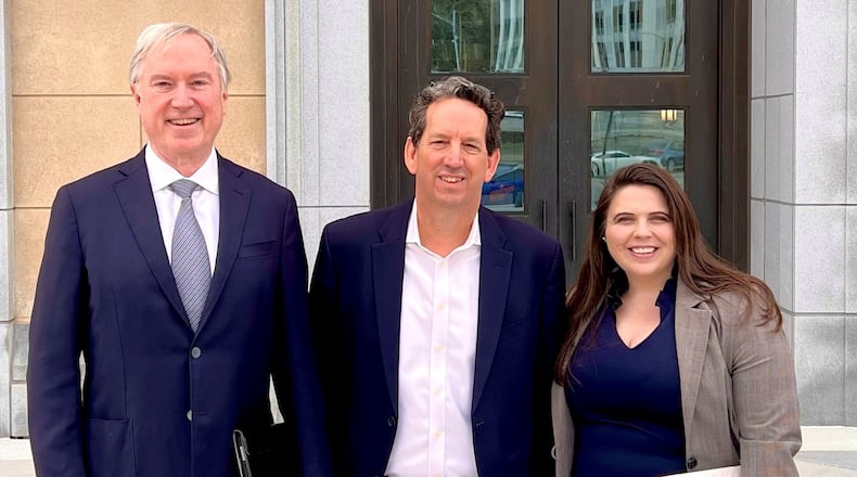 Outside court, Roger Stonecipher (middle) with his lawyers, Andrew Beal and Milinda Brown