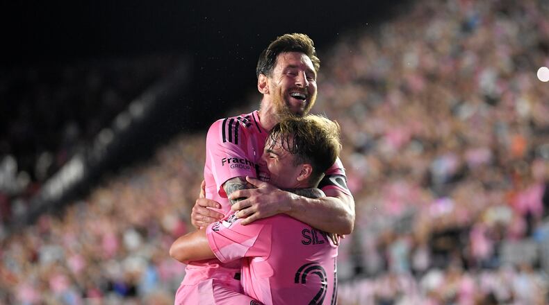 Inter Miami forward Lionel Messi, top, celebrates with forward Mateo Silvetti, bottom, after scoring during the first half of Game 3 in the first round of MLS soccer's Western Conference playoffs against Nashville SC in Fort Lauderdale, Fla., Nov. 8, 2025. (AP Photo/Michael Laughlin)