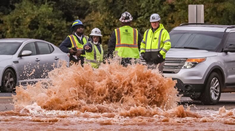 Brownish water covered a stretch of Glenwood Road in DeKalb County following a water main break Tuesday morning.