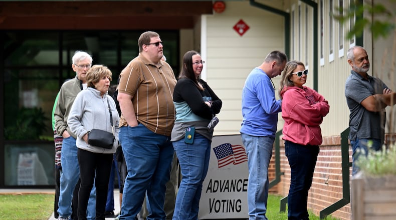 Voters line up to enter the North Cobb Senior Center in Acworth on Oct. 15, the first day of early voting in Georgia. (Hyosub Shin / AJC)