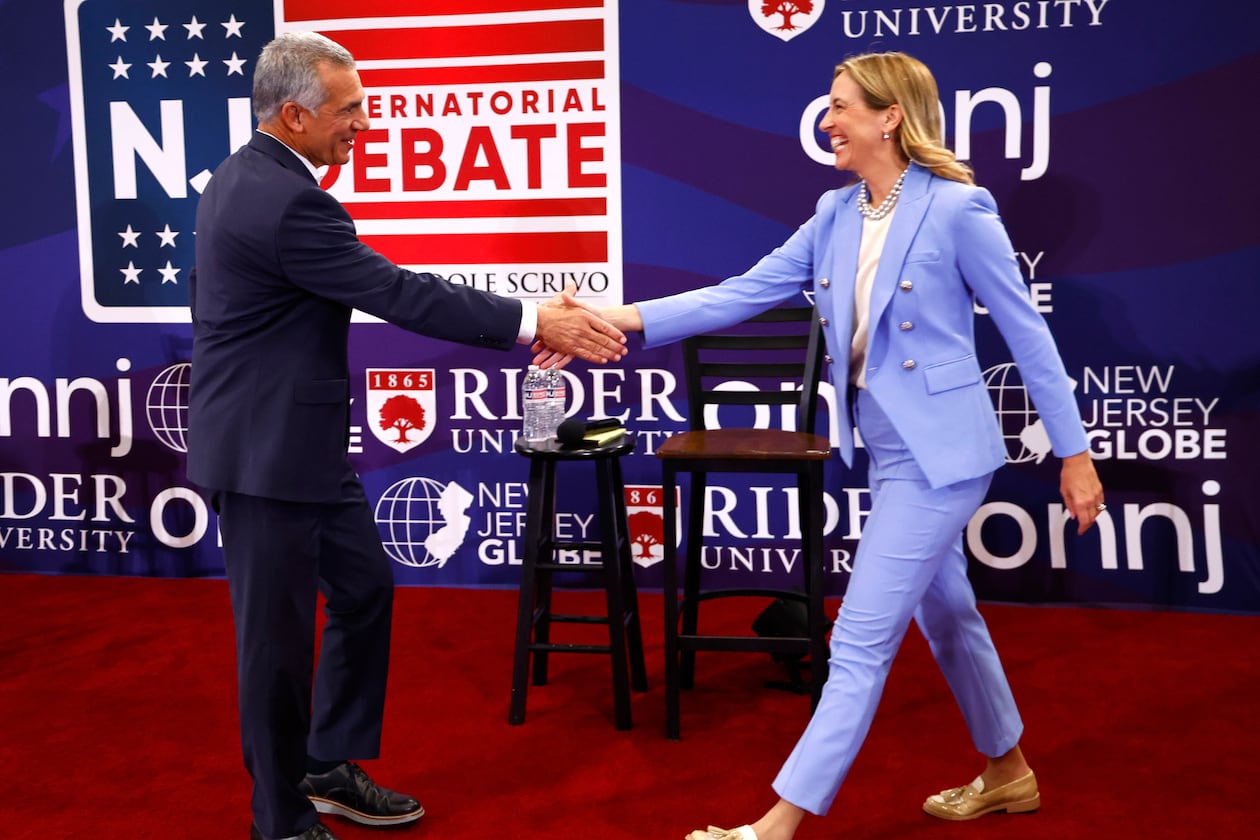 FILE - Republican candidate Jack Ciattarelli, left, shake hands with Democratic candidate for governor Mikie Sherrill, right, before a gubernatorial debate Sept. 21, 2025, in Lawrenceville, N.J. (AP Photo/Noah K. Murray, File)