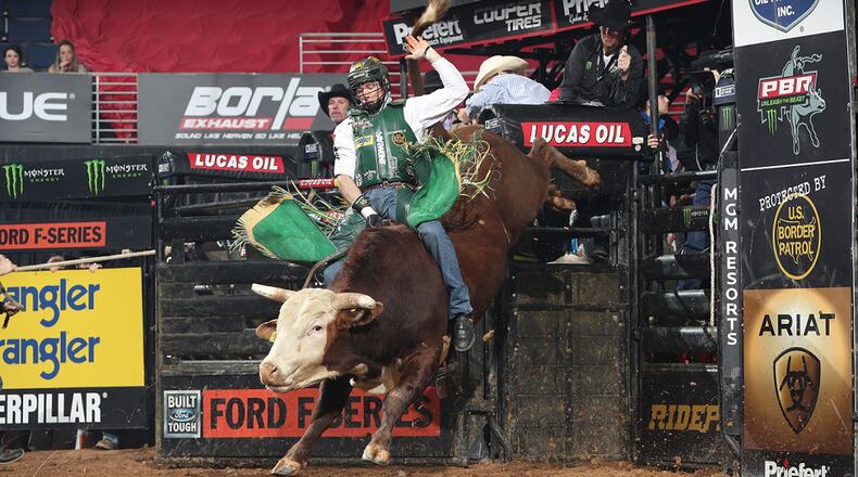 Sean Willingham attempts to ride M Rafter E Bucking Bulls' Dixie Explosion during the first round of the Duluth PBR Unleash the Beast. Photo by Andy Watson