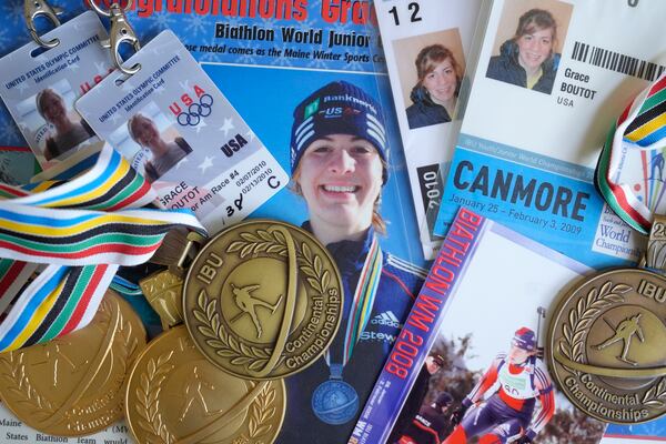 FILE - Biathlon competition medals, credentials and media clippings belonging to Grace Boutot, silver medalist in Youth World Championships in 2009, are displayed for a photograph at her home on Oct. 17, 2024, in Boston. (AP Photo/Steven Senne, File)