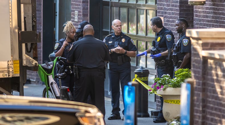 Emory University police are seen outside Emory Point off Clifton Road on Thursday morning after an emergency alert was issued about a shooting near campus.