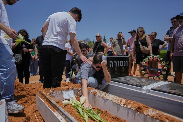 Relatives and friends of Daisy Yitzhaki, 85, who was killed during an Iranian missile attack, mourn during her funeral at Segula cemetery in Petah Tikva, Israel, Wednesday, June 18, 2025. (AP Photo/Oded Balilty)