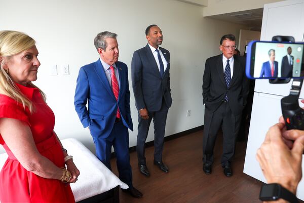 Gov. Brian Kemp (second from left) and Atlanta Mayor Andre Dickens (center) tour a new housing unit during the opening of the affordable housing and transitional program run by Georgia Works in the Historic Odd Fellows building in Atlanta on April 1, 2026. (Arvin Temkar/AJC)