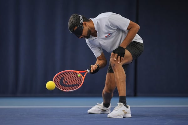 Blind tennis champion Naqi Rizvi plays a shot during a visually impaired tennis training session in London, Tuesday, May 20, 2025. (AP Photo/Kin Cheung)