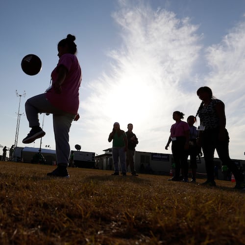 FILE - Immigrants play soccer at a new U.S. government holding center for migrant children, in Carrizo Springs, Texas, July 9, 2019. (AP Photo/Eric Gay, File)