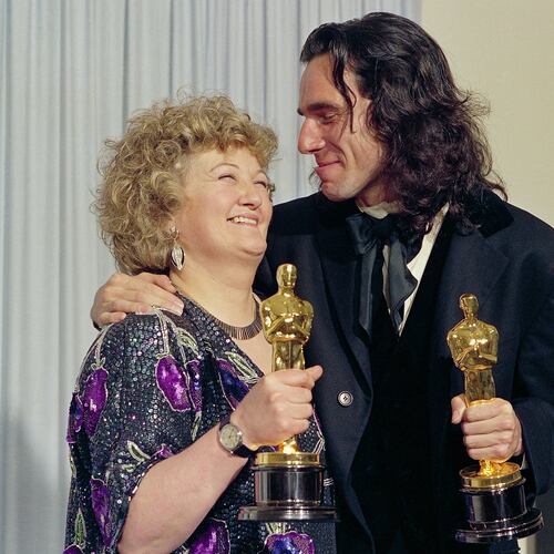 FILE - "My Left Foot" stars Brenda Fricker, winner of Oscar for best supporting actress, and Daniel Day Lewis, winner of Oscar for best actor, at the 62nd Annual Academy Awards in Los Angeles, March 26, 1990. (AP Photo/Bob Galbraith, File)