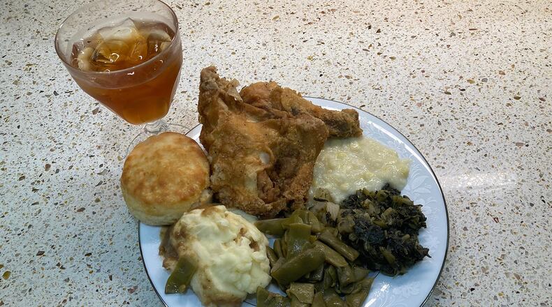 This re-creation of a typical Sunday dinner at Grandma King’s includes fried chicken, creamed corn, turnip greens, green beans, mashed potatoes, a biscuit and iced tea. (Bill King for The Atlanta Journal-Constitution)