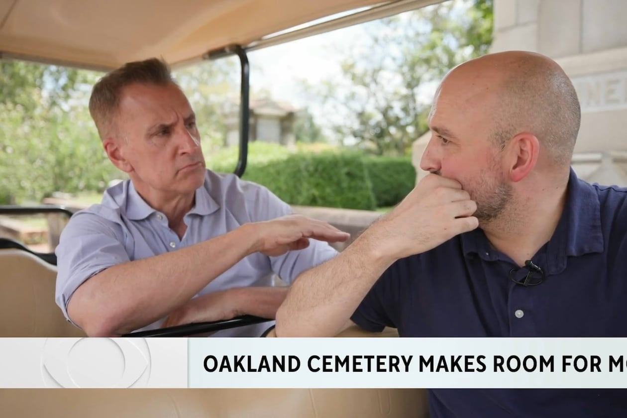 Brian Unger (left) during a CBS News Atlanta  piece he did on the Oakland Cemetery making plots available for sale for the first time in 145 years. He is speaking to Richard Harker, president of Historic Oakland Foundation. (CBS News Atlanta screenshot)
