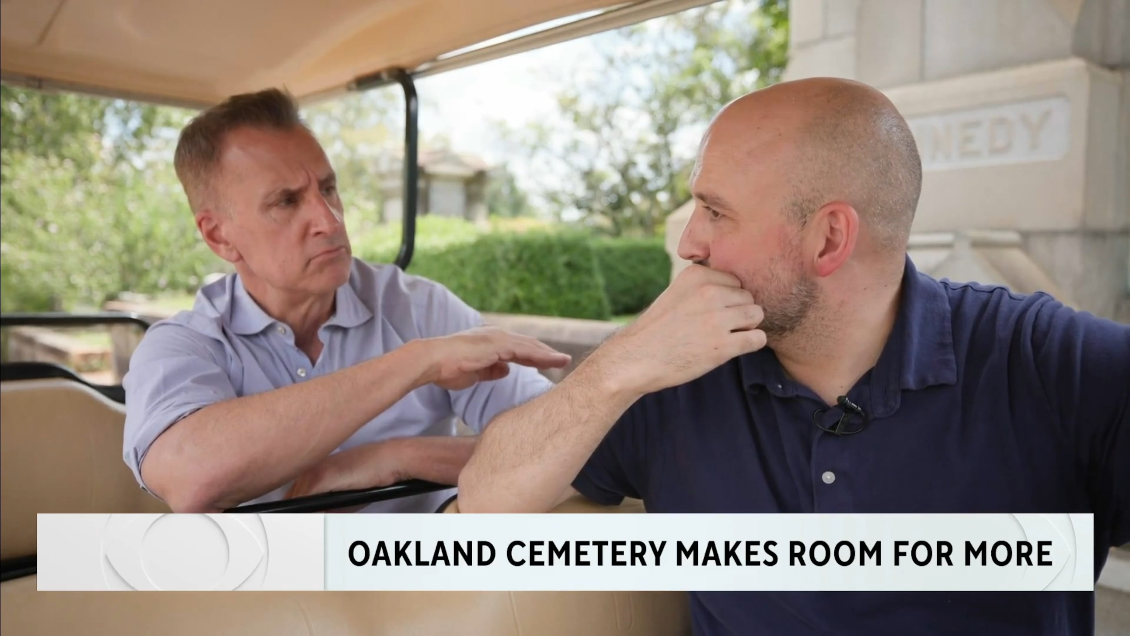 Brian Unger (left) during a CBS News Atlanta  piece he did on the Oakland Cemetery making plots available for sale for the first time in 145 years. He is speaking to Richard Harker, president of Historic Oakland Foundation. (CBS News Atlanta screenshot)