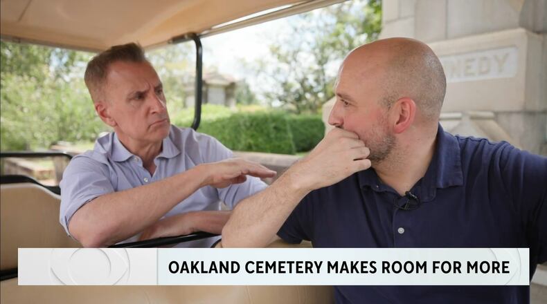 Brian Unger (left) during a CBS News Atlanta  piece he did on the Oakland Cemetery making plots available for sale for the first time in 145 years. He is speaking to Richard Harker, president of Historic Oakland Foundation. (CBS News Atlanta screenshot)