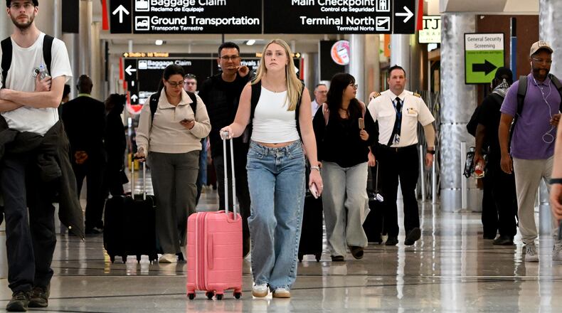 Afternoon travelers make their way through Hartsfield-Jackson Atlanta International Airport on March 27, 2026. This coming Friday is expected to be one of the busiest travels days on record for the airport. (Hyosub Shin/AJC)