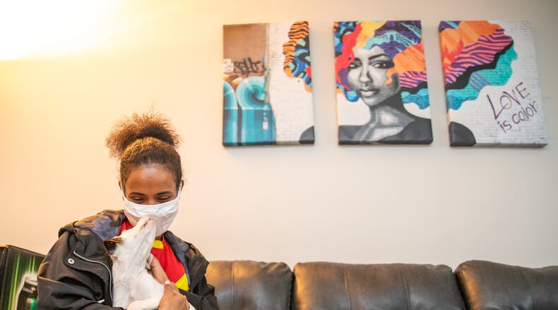 Rahel Tsada is a mother of three and an Ethiopian refugee who lived at the the Women’s Resource Center safe house in DeKalb County when the coronavirus lockdown happened. She has since moved to her own home and recently adopted a puppy. On Thursday, Tsada visited the center where she once lived and talked about her journey. "There’s a lot of love here,” she said.  (Jenni Girtman for The Atlanta Journal-Constitution)