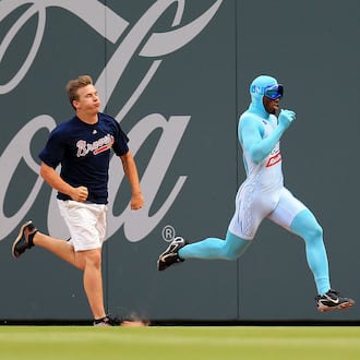 Nigel Talton (right), who was the original "Freeze," races a Braves fan between innings during a game in 2020. (AJC file)