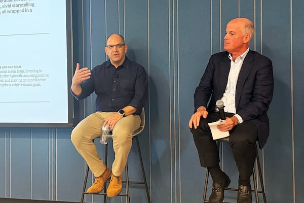 Andrew Morse (left), president and publisher of The Atlanta Journal-Constitution, and Paul Curran, his successor, speak to the staff of the AJC at a town hall meeting May 11, 2026. (Sandra Brown/AJC)
