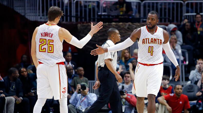 Atlanta Hawks guard Kyle Korver (26) and forward Paul Millsap (4) react in the second half of an NBA basketball game against the Detroit Pistons on Friday, Dec. 30, 2016, in Atlanta. The Hawks won the game 105-98. (AP Photo/Todd Kirkland)