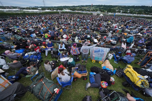 Revellers queue for entry, on the first day of the Glastonbury Festival at Worthy Farm, in Somerset. England, Wednesday June 25, 2025. (Yui Mok/PA via AP)