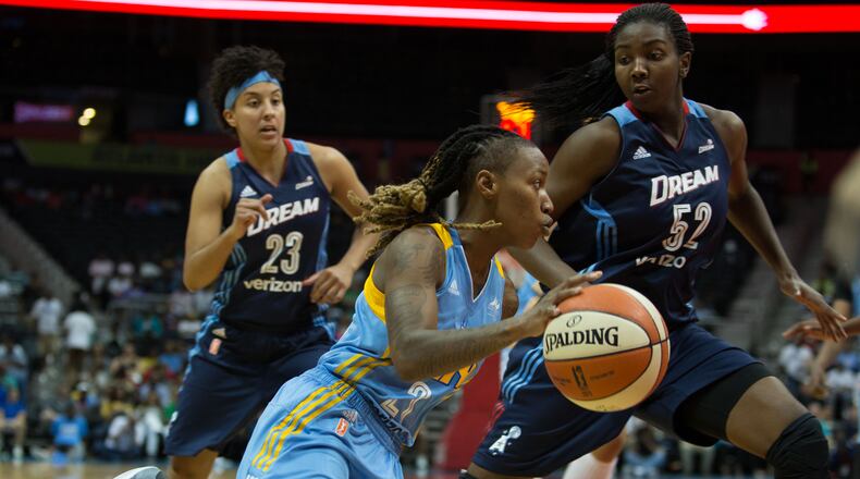 Chicago Sky guard Jamierra Faulkner (21) , center, drives to the basket while being defended by Dream center Elizabeth Williams (52) and guard Layshia Clarendon (23) during a game on Sunday at Philips Arena. BRANDEN CAMP/SPECIAL