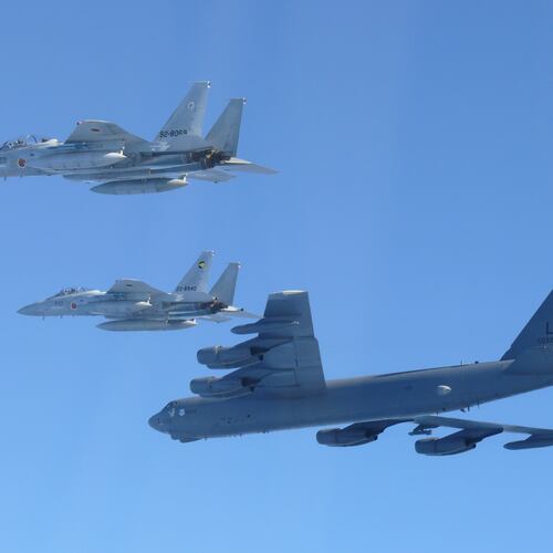 This photo provided by Japan's Ministry of Defense shows the Japan Air Self-Defense Force's F-15 fighters holding a joint military drill with the U.S. B-52 bomber in the vicinity of Japanese airspace on Wednesday Dec. 10, 2025. (Japan's Ministry of Defense via AP)