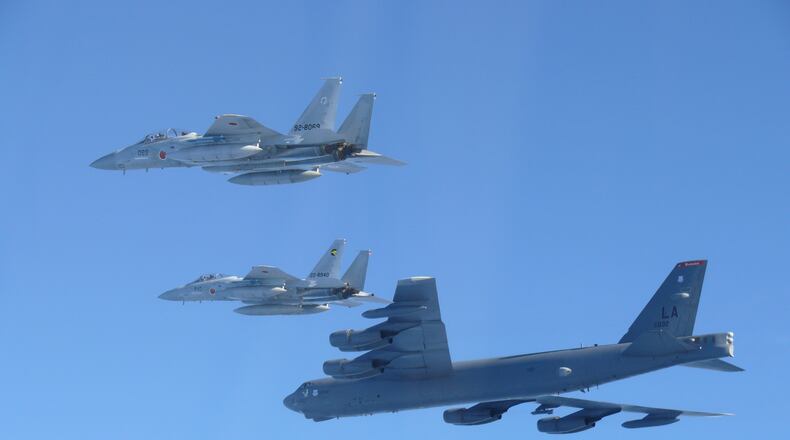 This photo provided by Japan's Ministry of Defense shows the Japan Air Self-Defense Force's F-15 fighters holding a joint military drill with the U.S. B-52 bomber in the vicinity of Japanese airspace on Wednesday Dec. 10, 2025. (Japan's Ministry of Defense via AP)