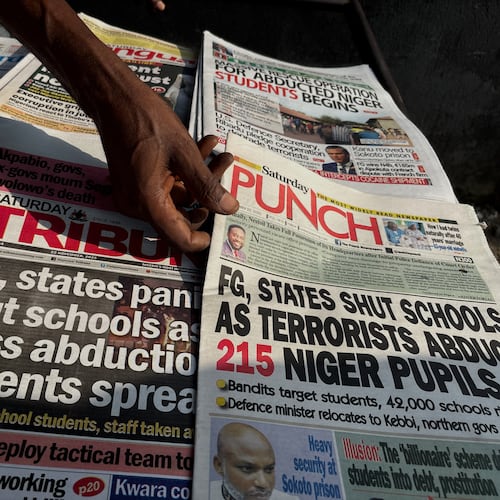 A street vendor in Lagos displays local newspapers with headlines on gunmen abducting schoolchildren and staff of the St. Mary's Catholic Primary and Secondary School in Papiri community in Nigeria, Saturday, Nov. 22, 2025. (AP Photo/Sunday Alamba )