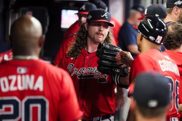 Teammates greet Braves pitcher Grant Holmes following his May 2 start against the Dodgers.