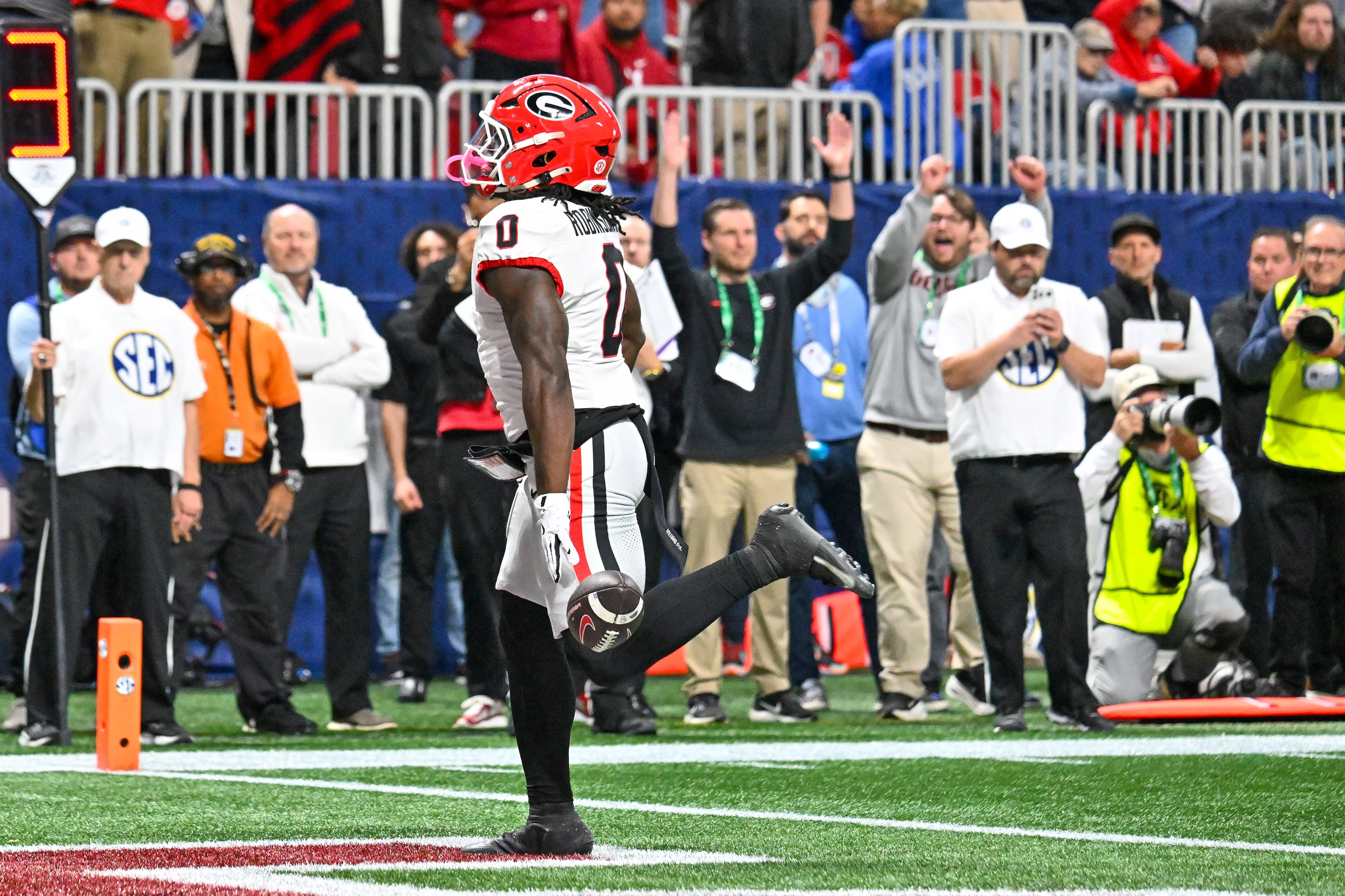 Georgia running back Roderick Robinson II (0) scores the game's first touchdown on a short run past the Alabama defense during the first quarter of the SEC Championship game at Mercedes-Benz Stadium, Saturday, Dec. 6, 2025, in Atlanta. (Hyosub Shin / AJC)