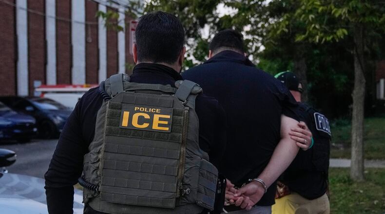 FILE - U.S. Immigration and Customs Enforcement agents make an arrest during an early morning operation in Park Ridge, Ill., Sept. 19, 2025. (AP Photo/Erin Hooley, File)