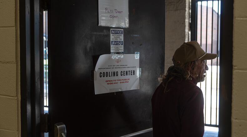 Daniel Aragonez leaves a cooling center in Los Angeles, Friday, July 31, 2026. (AP Photo/Jae C. Hong)
