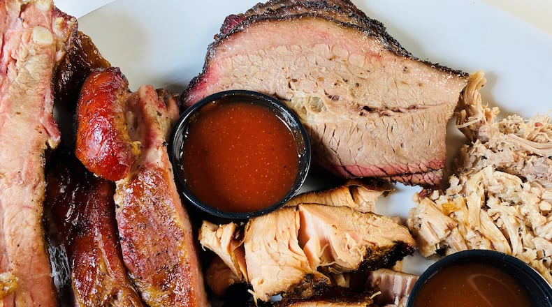 The Pitmaster Platter at Ford’s BBQ includes pulled pork, brisket, turkey, sausage, ribs and a choice of four sides. Bob Townsend for The Atlanta Journal-Constitution