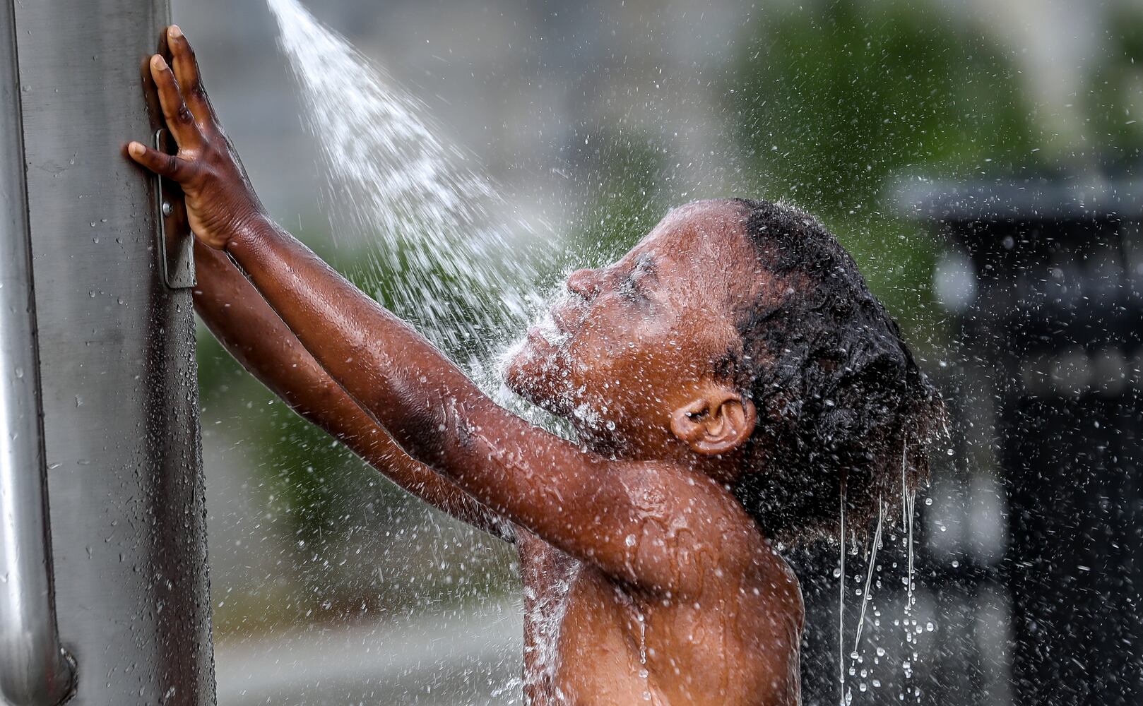 Having some summertime fun, Isannah Brightwell, 5, frolicked in the water at Rodney Cook Sr. Park at Vine Street and Joseph E. Boone Boulevard in northwest Atlanta on Thursday, June 15, 2023. (John Spink / John.Spink@ajc.com)



