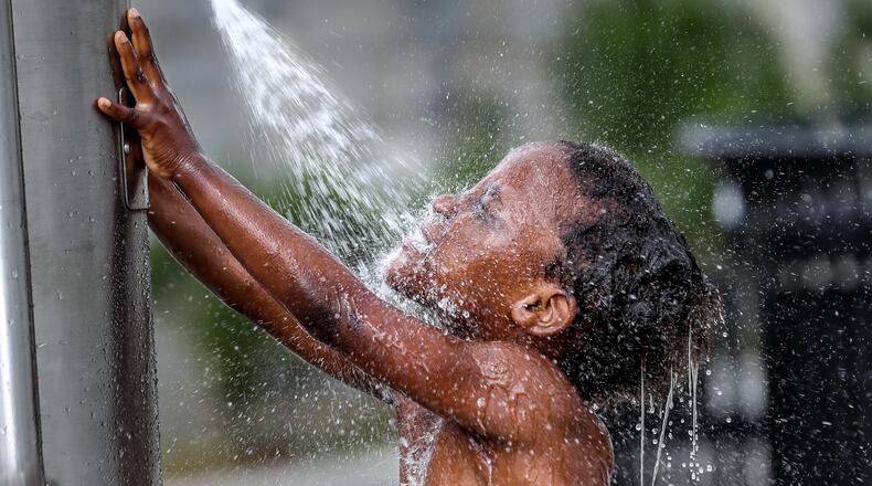 Isannah Brightwell, 5, frolicked in the water at Rodney Cook Sr. Park in Historic Vine City on June 15, 2023. (John Spink / John.Spink@ajc.com)