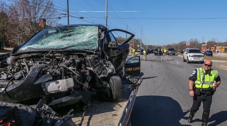This car collided with a dump truck on Roswell Road in Cobb County earlier this month. JOHN SPINK / JSPINK@AJC.COM