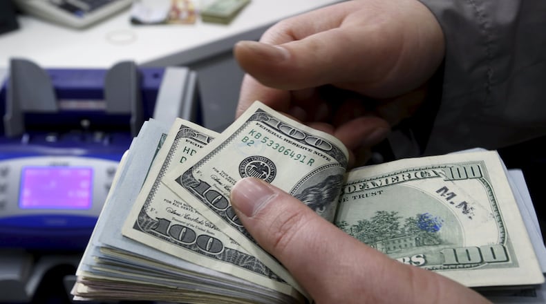 A money changer counts U.S. dollar bills at a currency exchange office in central Istanbul April 15, 2015. Turkish Economy Minister Nihat Zeybekci said on Wednesday the lira's slide to record lows was not a cause for concern and reflected global developments, arguing against forex intervention and saying the currency will find its own balance. He also told a meeting in Istanbul that he expected first quarter year-on-year growth of around 1.5 percent, and full year growth exceeding last year's 2.9 percent. REUTERS/Murad Sezer