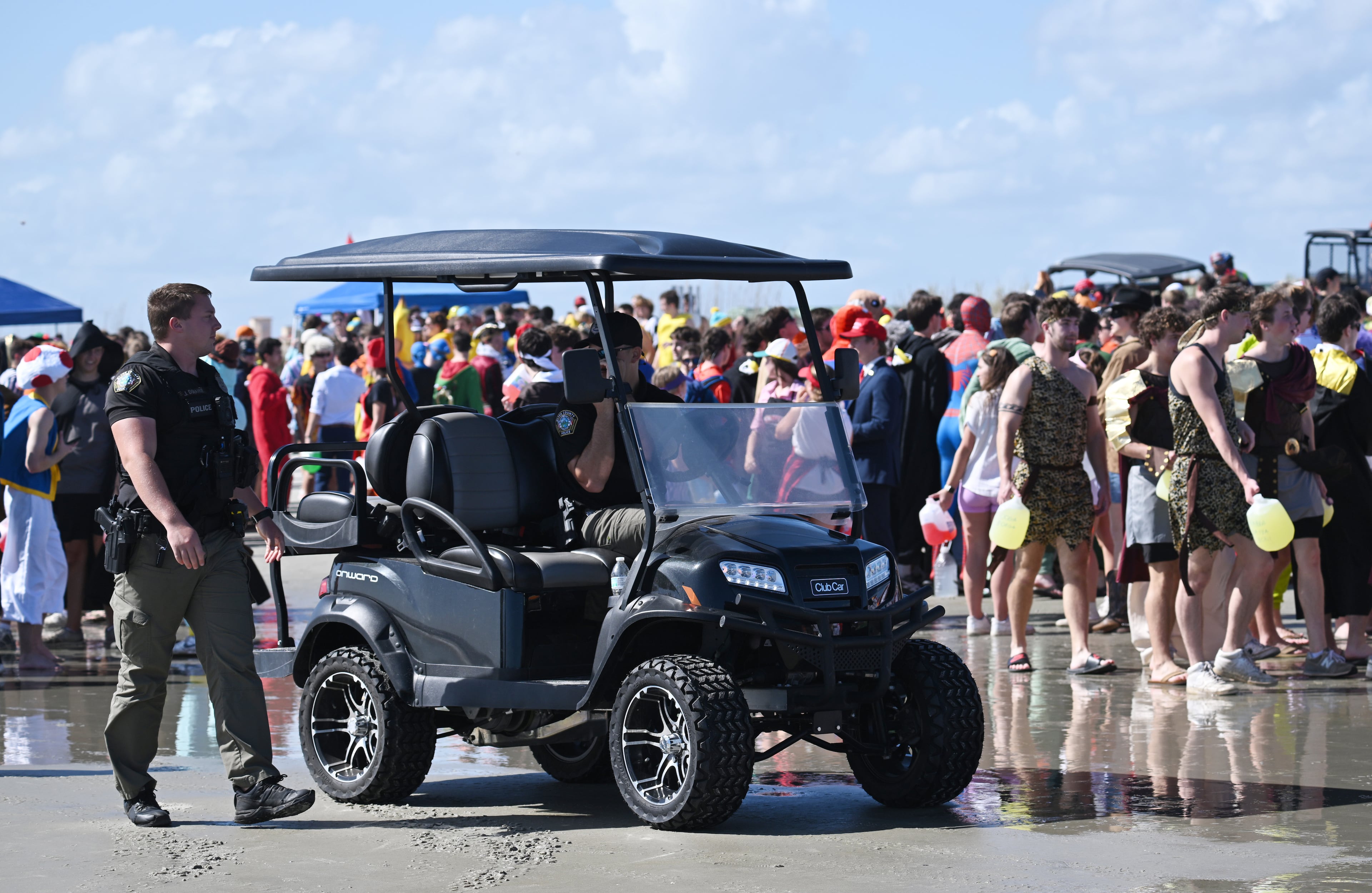 Local enforcement officers monitor during the annual “Frat Beach” party for the weekend of the Georgia-Florida football game on St. Simons Island, Friday, November 1, 2024. On the weekend of the Georgia-Florida football game, St. Simons Island’s East Beach becomes “Frat Beach,” an open-air party teeming with thousands of college students. (Hyosub Shin / AJC)