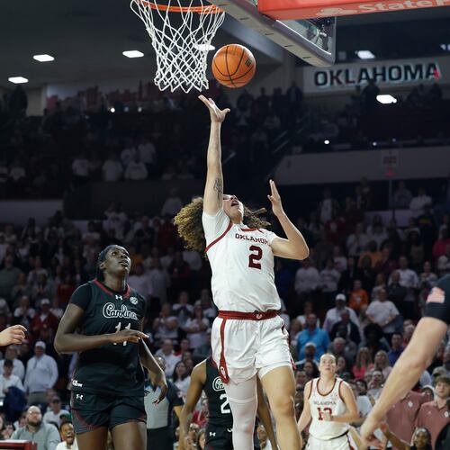 Oklahoma guard Aaliyah Chavez (2) goes up for a basket beside South Carolina center Madina Okot (11) during overtime of a NCAA college basketball game Thursday, Jan. 22, 2026 in Norman, Okla. (AP Photo/Alonzo Adams)