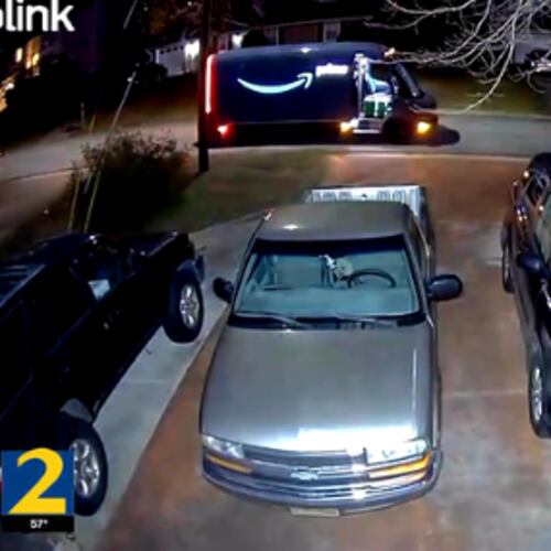 Camera footage obtained by Channel 2 Action News shows the aftermath of the shooting with the USPS vehicle on a neighbor's yard. (Channel 2 Action News)