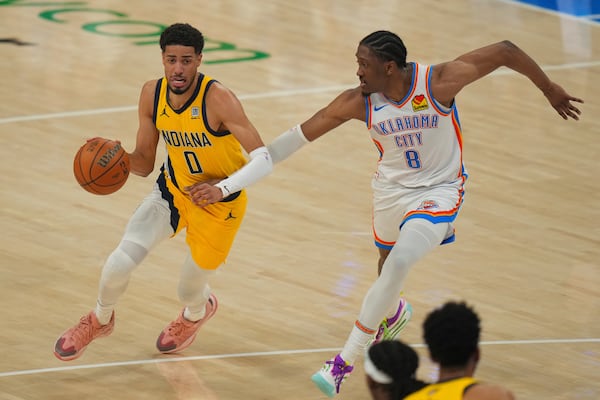 Indiana Pacers guard Tyrese Haliburton (0) drives as Oklahoma City Thunder forward Jalen Williams (8) defends during the first half of Game 5 of the NBA Finals basketball series, Monday, June 16, 2025, in Oklahoma City. (AP Photo/Nate Billings)