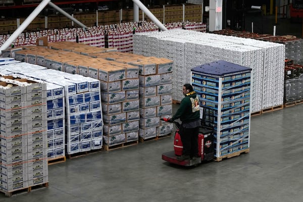 Rich Faafiu, senior operations manager, moves crates of food in the San Francisco-Marin Food Bank warehouse in San Francisco, Wednesday, July 2, 2025. (AP Photo/Jeff Chiu)