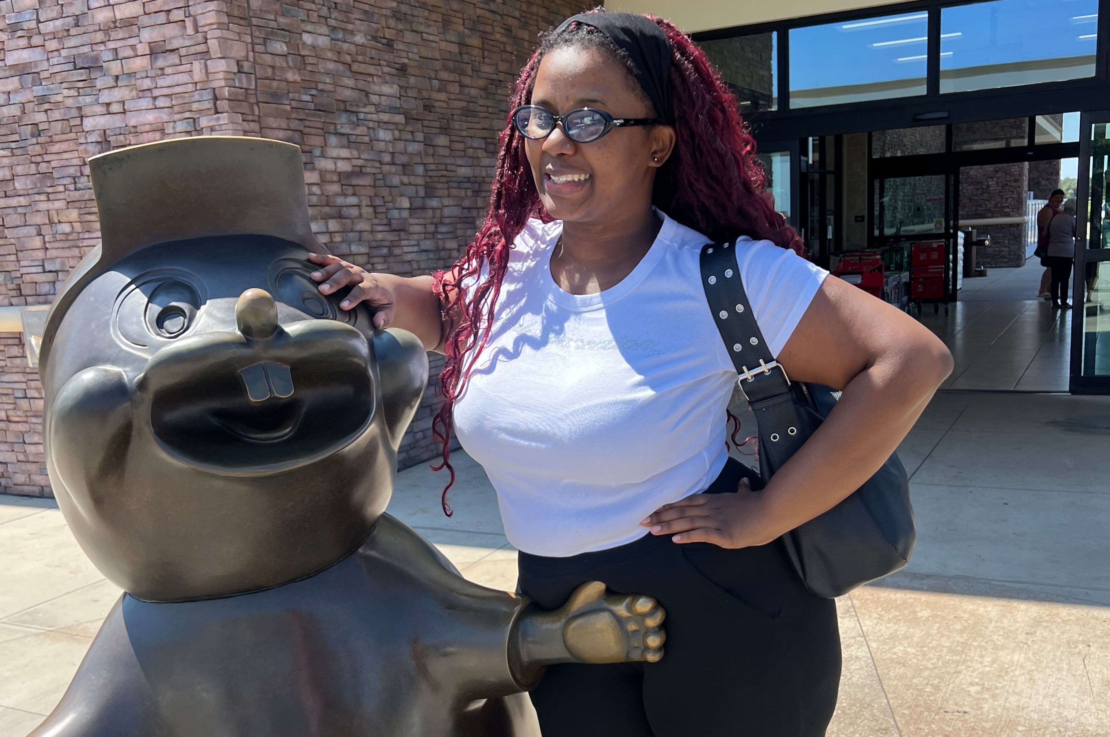 Amariyah Callender of Atlanta recently visited the Warner Robins Buc-ee's twice in one week. Here she poses with a statue of the Buc-ee's mascot. (Courtesy)