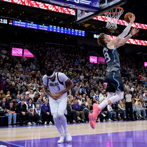 Utah Jazz forward Lauri Markkanen, center, lays the ball to the basket as Dallas Mavericks forward Anthony Davis, left, is injured on the play during the second half of an NBA basketball game against the Dallas Mavericks, Thursday, Jan. 8, 2026, in Salt Lake City. (AP Photo/Tyler Tate)