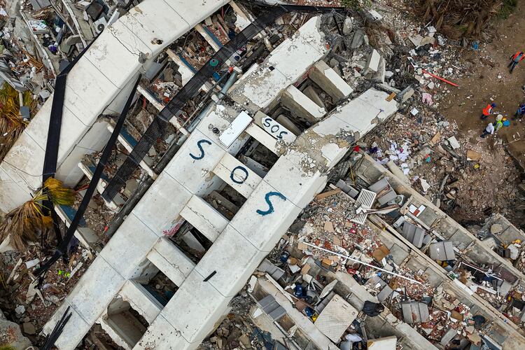 SOS is seen on collapsed buildings following the June 24 twin earthquakes in Caraballeda in the state of La Guaira, Venezuela, Thursday, July 2, 2026. (Miguel Medina/Pool Photo via AP)