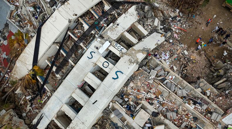 SOS is seen on collapsed buildings following the June 24 twin earthquakes in Caraballeda in the state of La Guaira, Venezuela, Thursday, July 2, 2026. (Miguel Medina/Pool Photo via AP)
