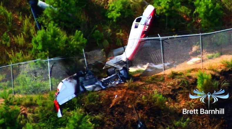 A small plane is on its side at the edge of a runway in Cherokee County. (Credit: Brett Barnhill)